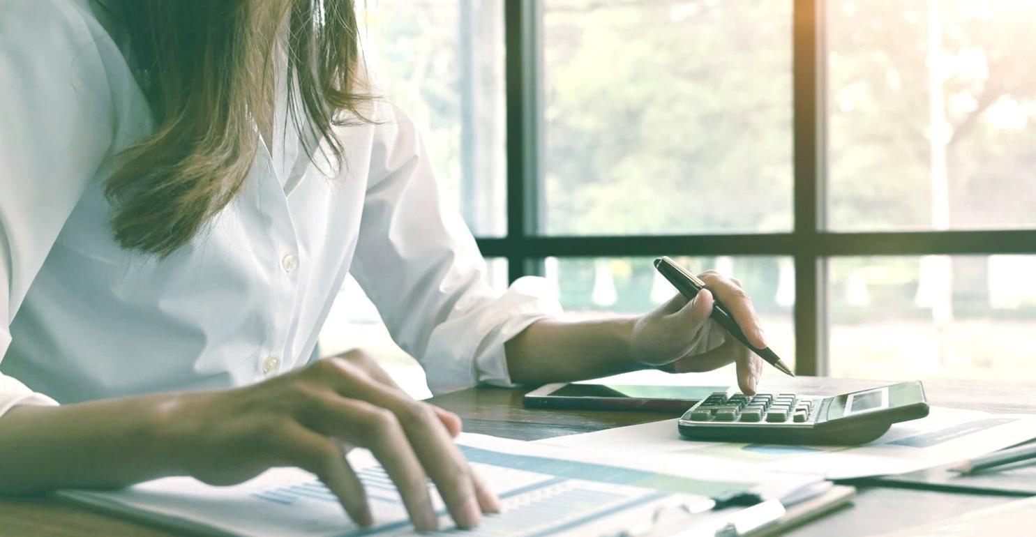 Financial planning workspace with documents and laptop